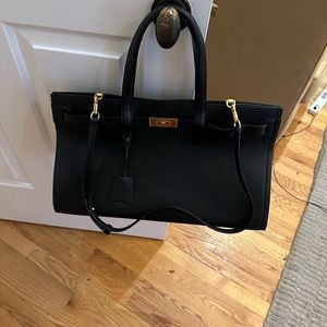 Tory Burch, never used, black leather and gold hardware with lock, bag